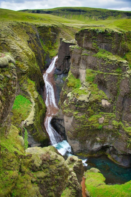 the small waterfall in the middle of the cliff