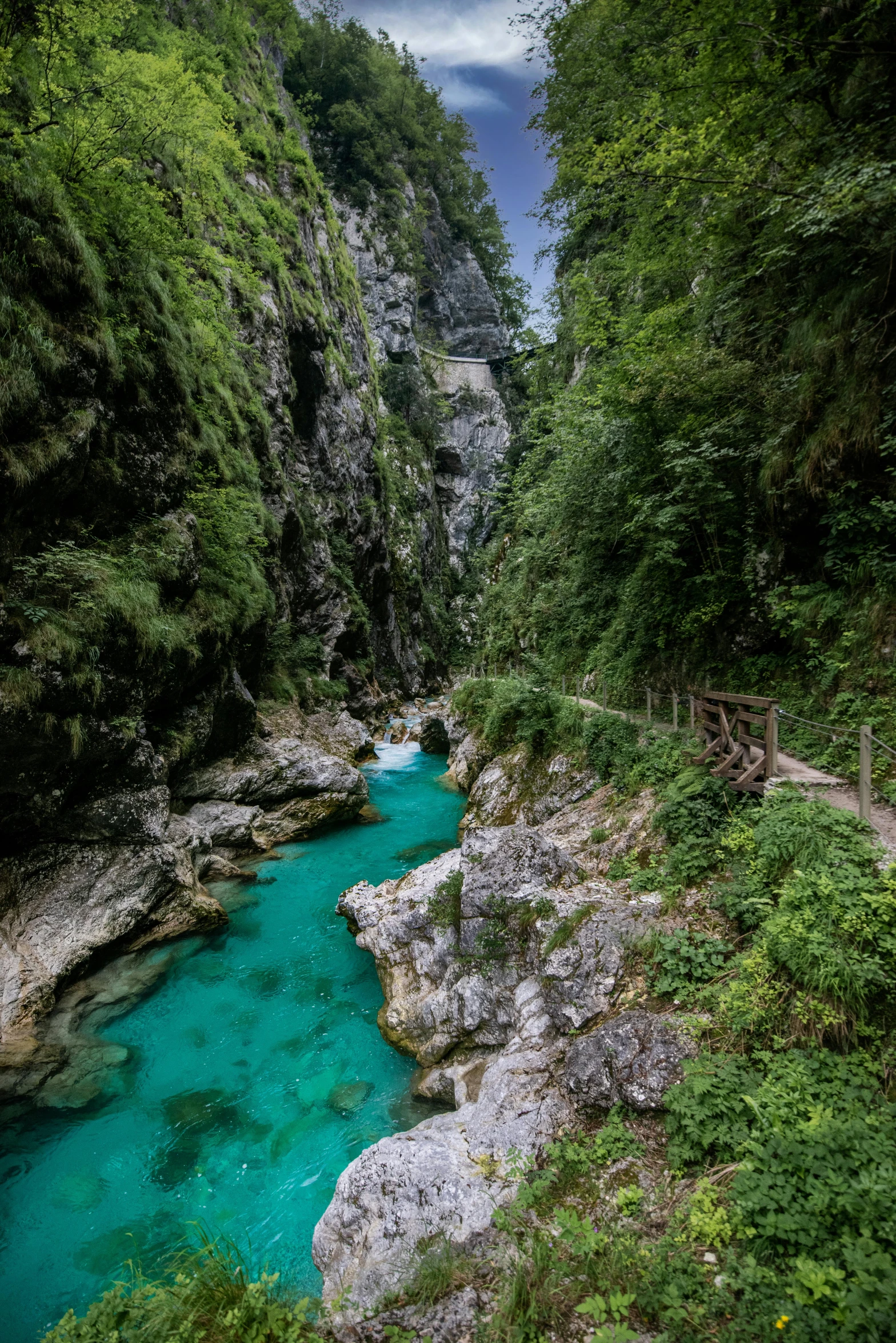 the small blue river is near the mountains