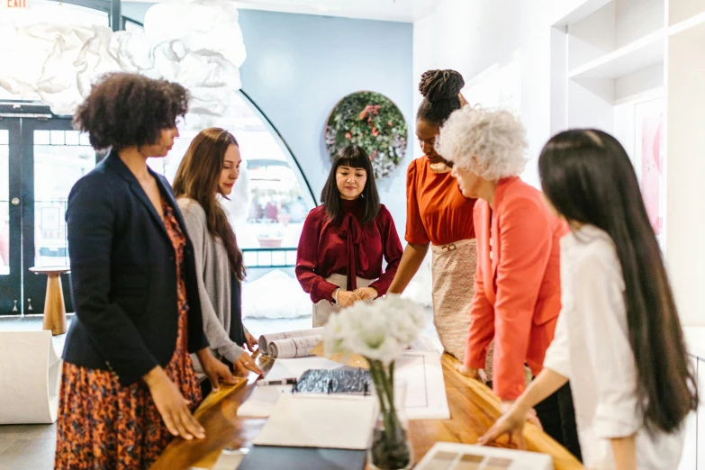 a group of people looking at pictures on display