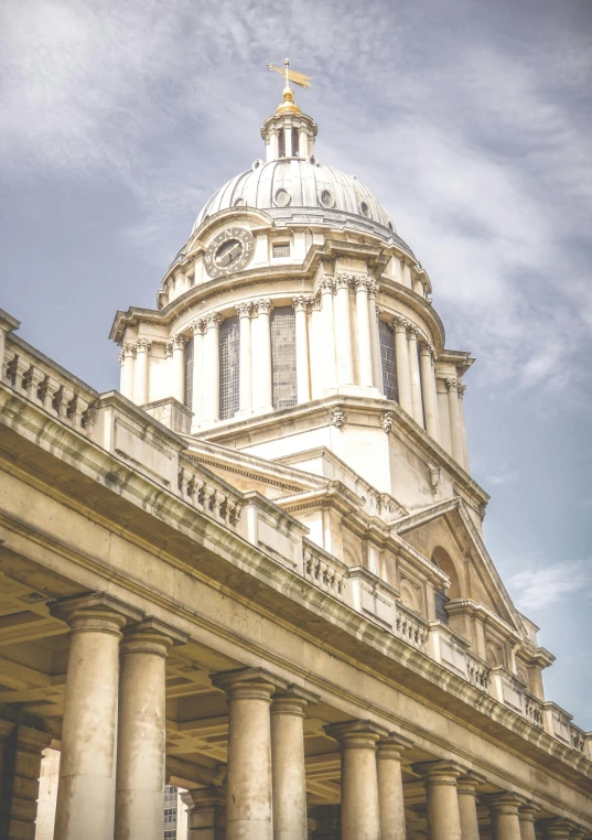 the side of a building with large columns and domed structure