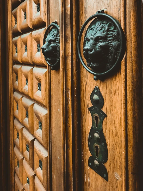 a wooden door with black metal handles