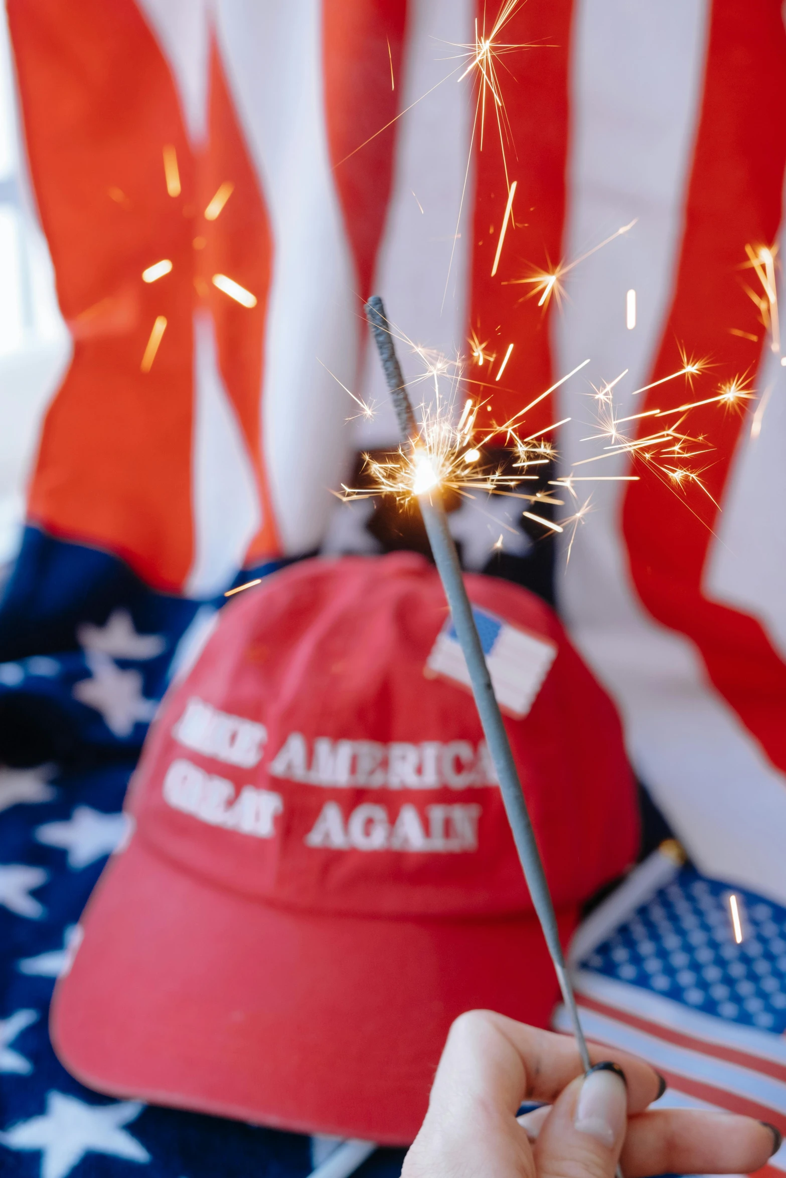 a red hat being held up in front of american flag