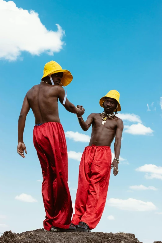 two people in red and yellow standing together