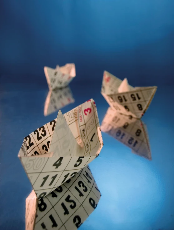 origami paper boats with numbers and numbers on them