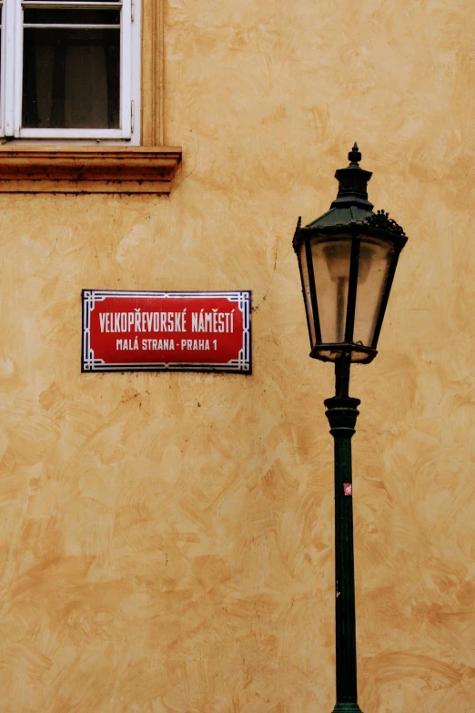 a streetlight and a sign on the side of a building