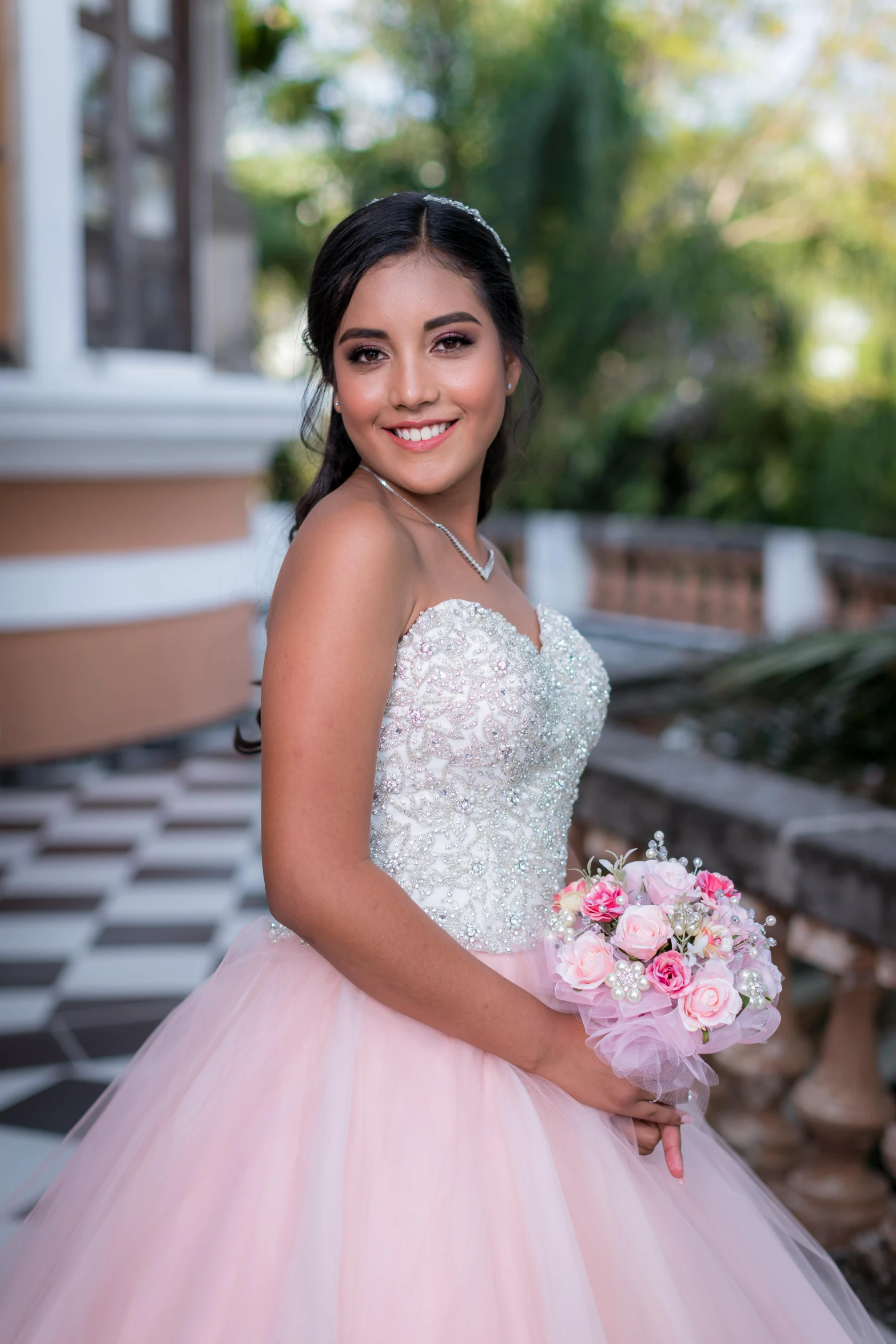 the woman is posing with her bouquet of flowers