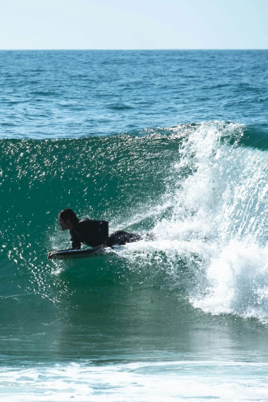 a man riding on top of a wave on top of a surfboard