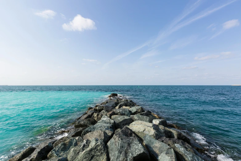 a sea line next to a jetty with lots of water