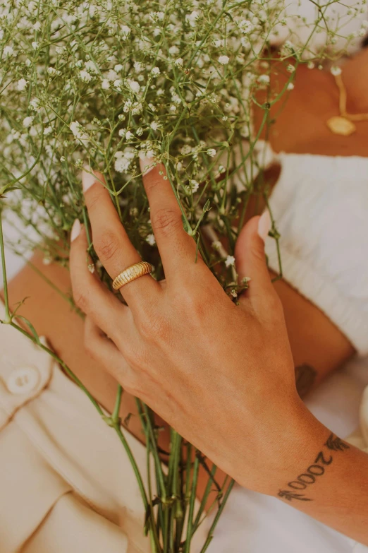 there is a woman holding some flowers and ring