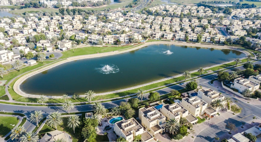 the aerial view of residential and large pond