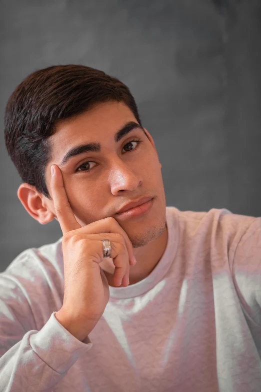 man posing with his hand under his chin