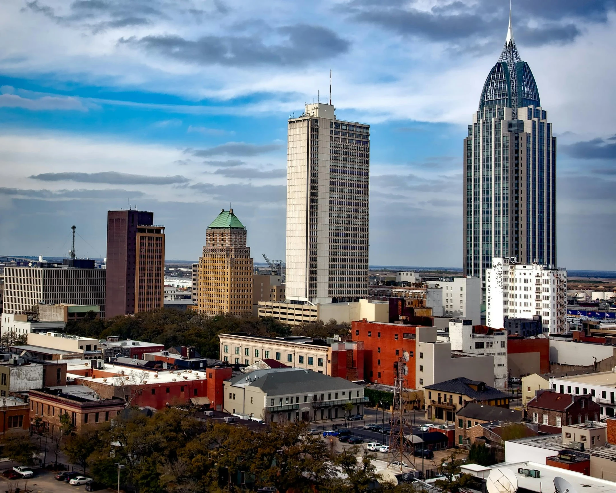 many buildings are shown with blue and white clouds