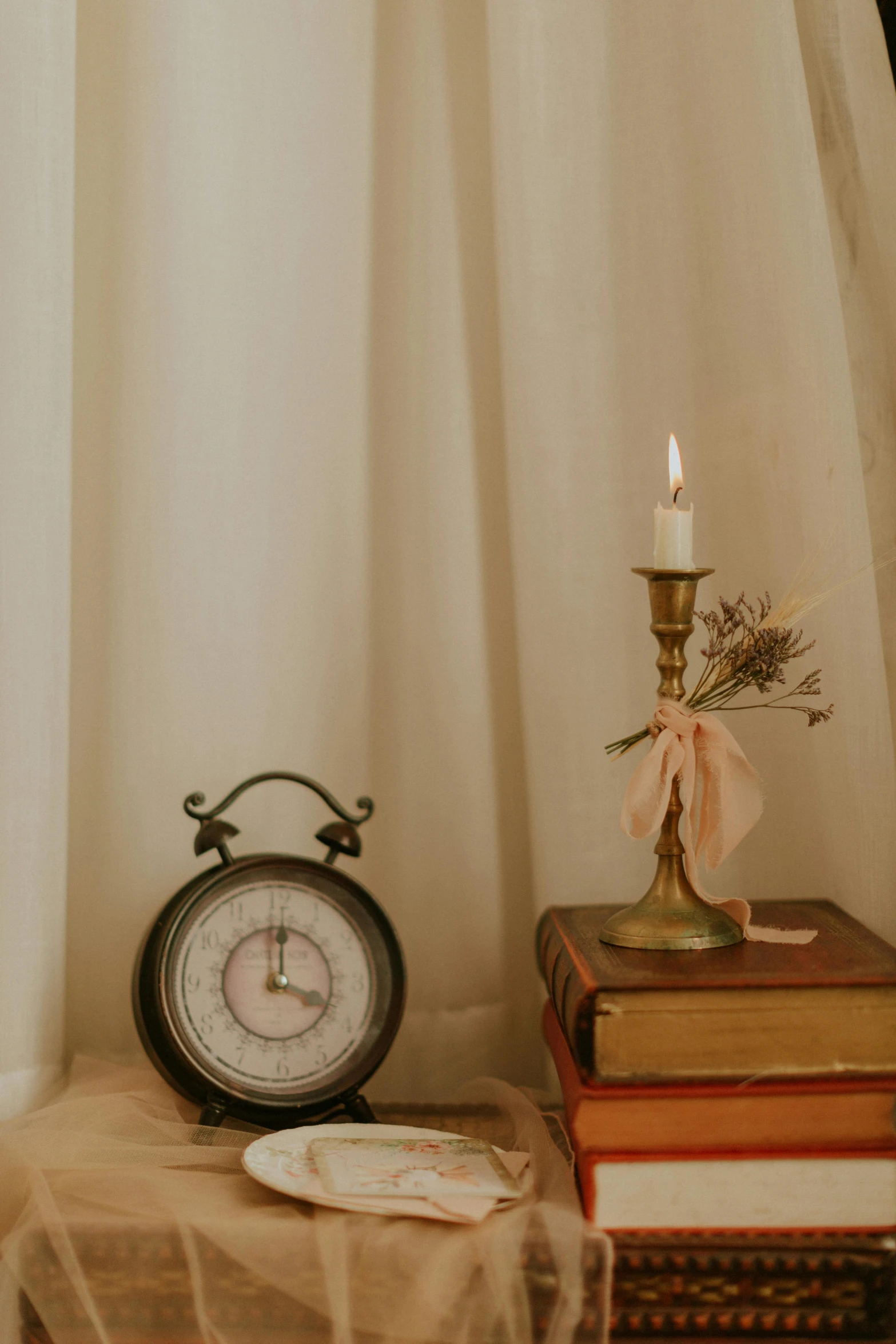 a couple of books on a table with a clock