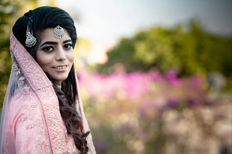 a woman wearing a veil and a pink veil