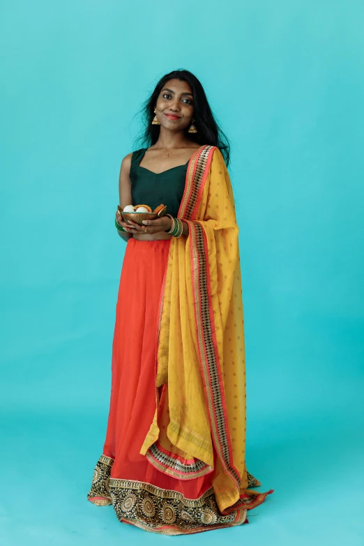 woman in indian dress, standing with arms folded