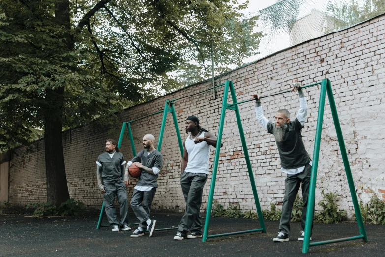 people standing on swings with hands holding onto them