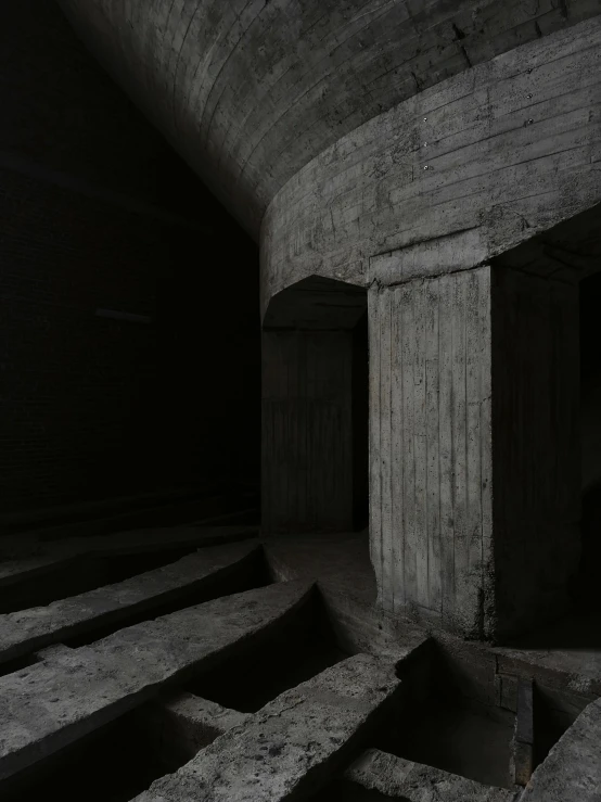 the dark room has stone stairs and black walls