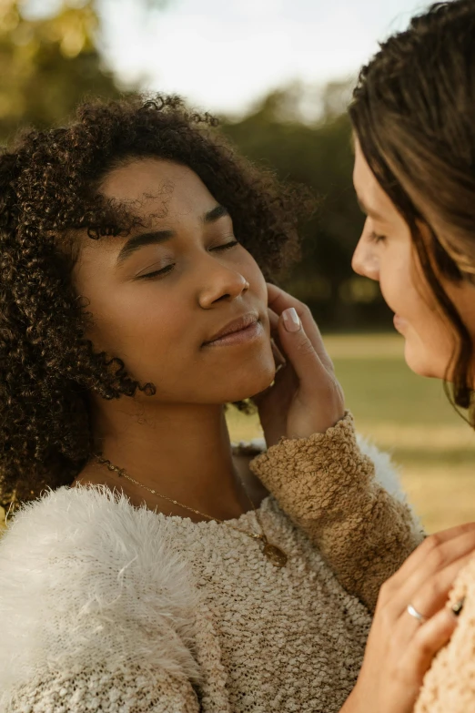 two women are talking and holding each other's hands