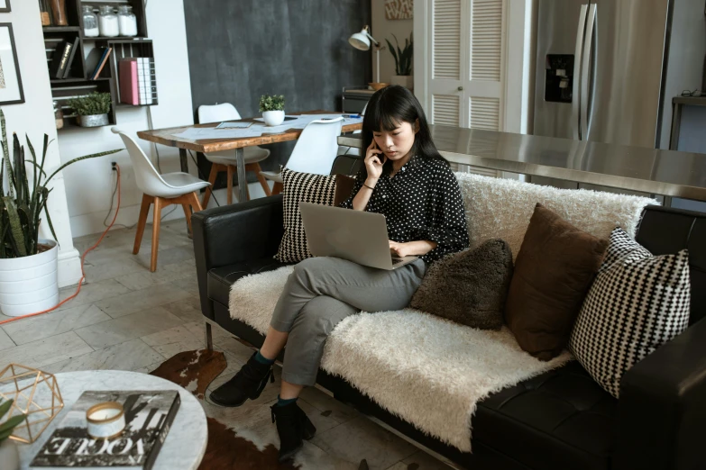 a person is on a couch with a laptop