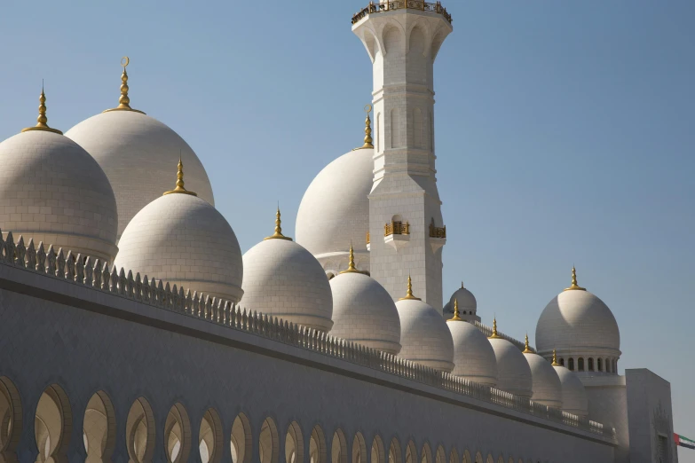 an old, white building with many white domes