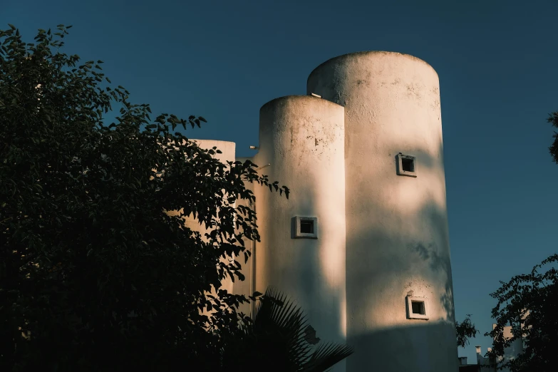 there are three tall buildings on a street