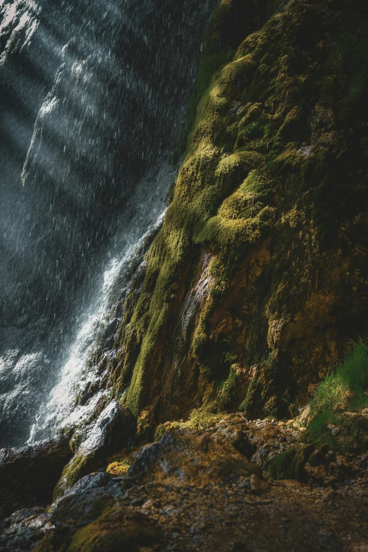 a rock cliff with the ocean going by