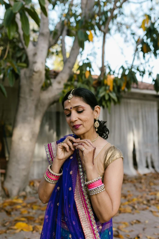a woman in a sari is holding onto her hands