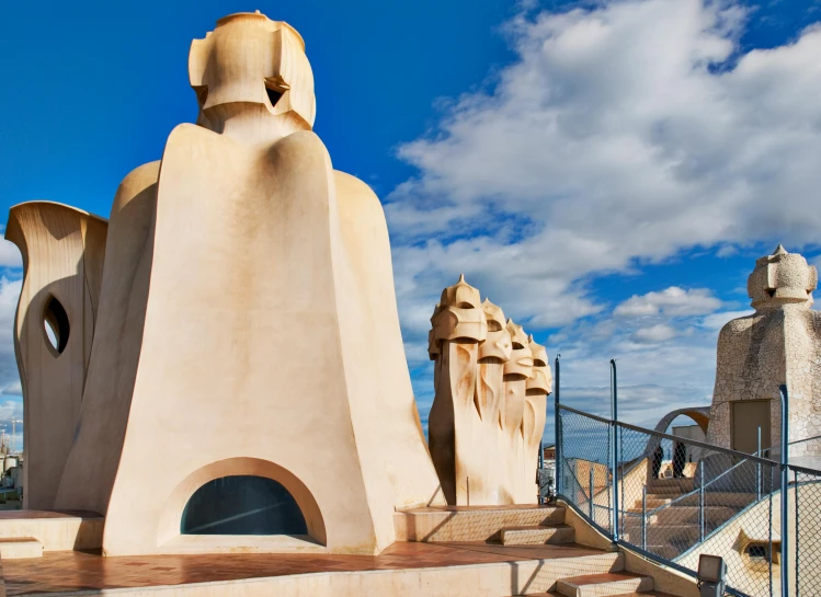 a group of large chimneys surrounding some buildings