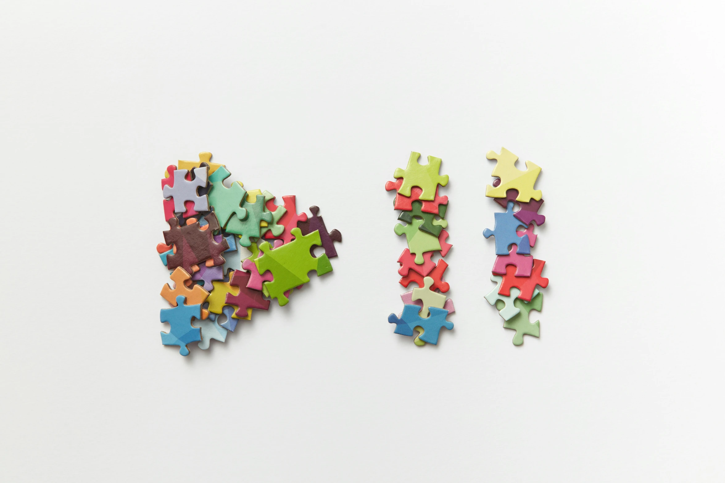 a group of multicolored pieces with a white background