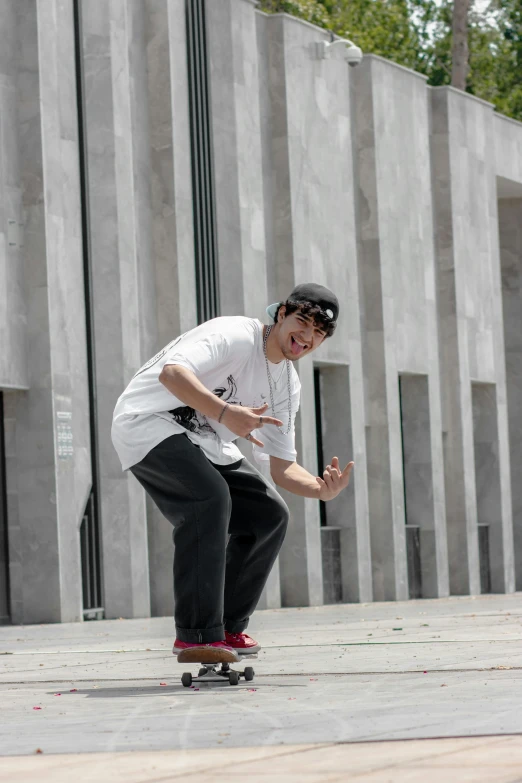 a boy riding a skateboard down the side of a street