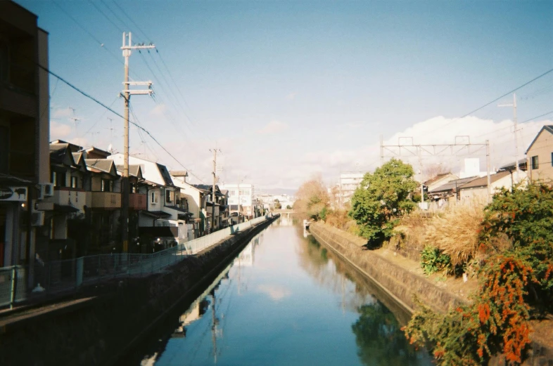 a waterway surrounded by small houses on a clear day