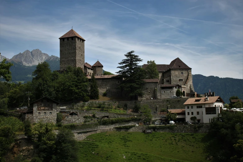 an old, majestic castle is seen on a hill