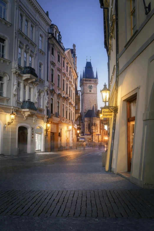 a cobblestone street leads into a large building