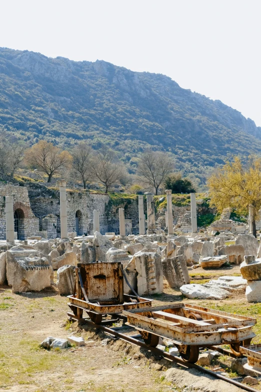 an ancient stone building with a mountain behind it