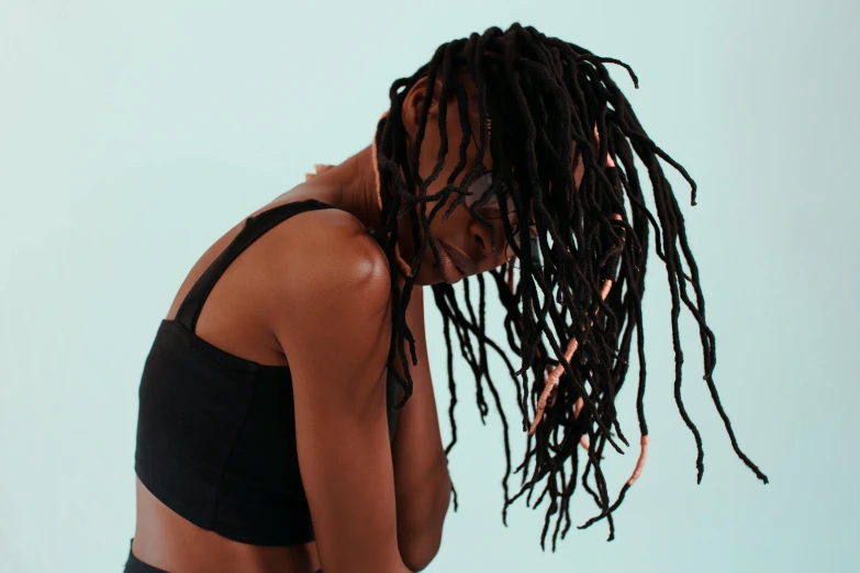 a woman with dread locks looks at her phone