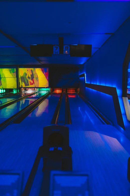 bowling lanes with lanes lined up in blue lighting