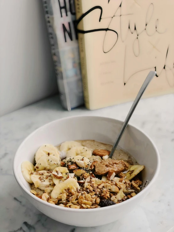 a bowl filled with cereal topped with banana slices