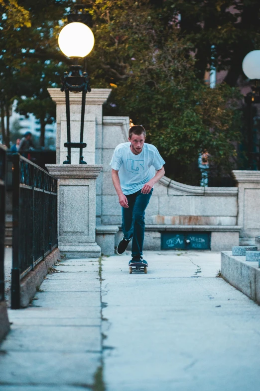 a man is riding a skateboard on a sidewalk