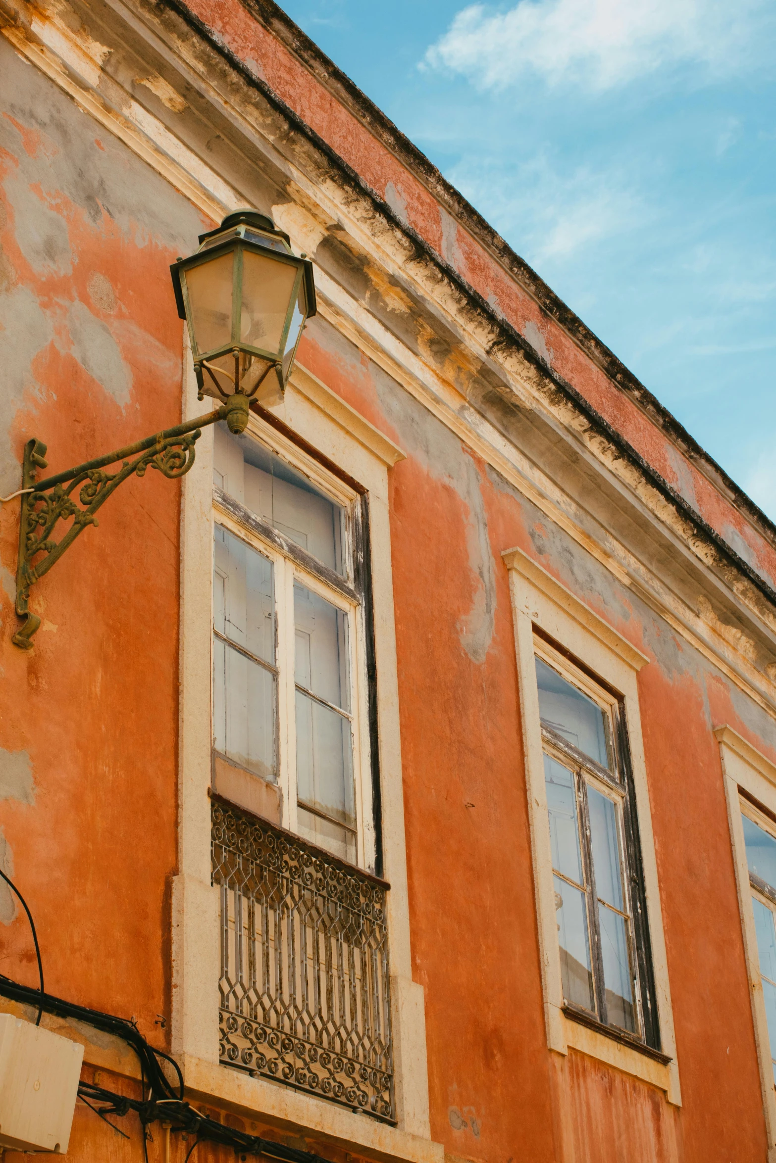 a old, worn out building with a street light in front of it