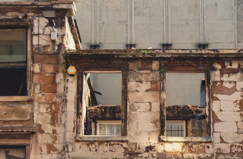 an old abandoned building with several windows