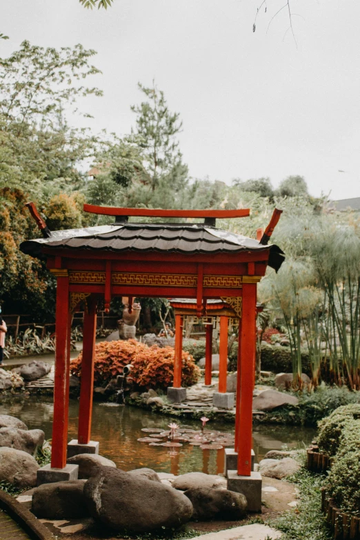 a small oriental pagoda stands alone in a garden