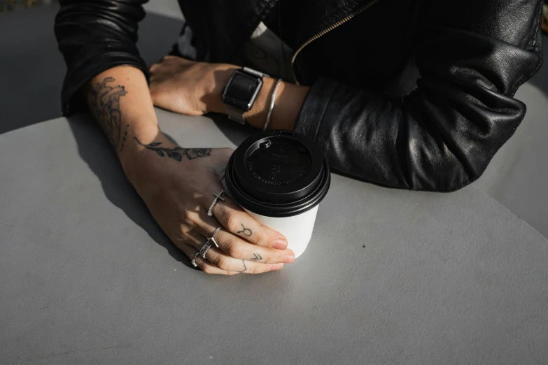 a man is holding onto a white cup