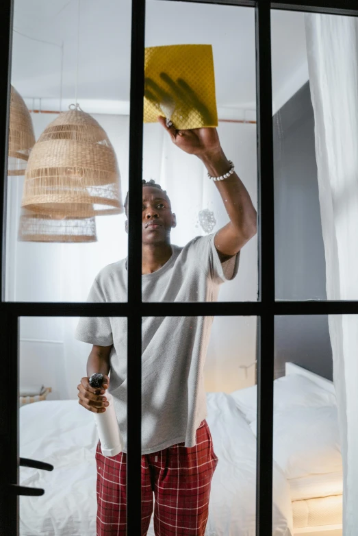 a man looking through a window at himself