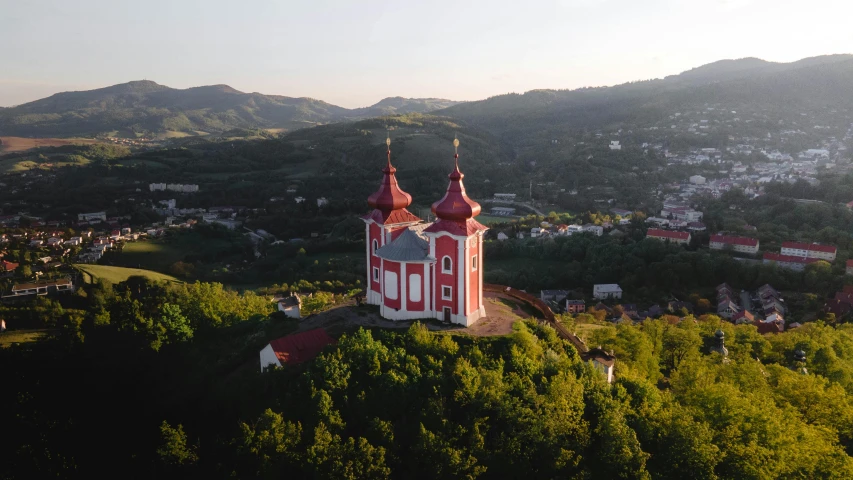 a red church with two steeples on top