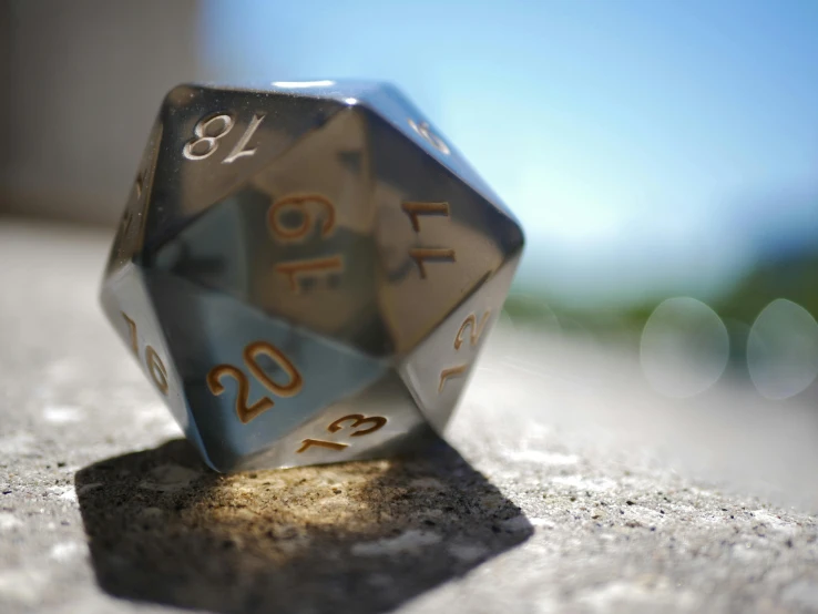 a metal dice with gold numbers on it