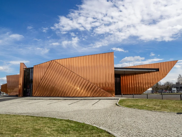 an orange building that has curved wooden sides