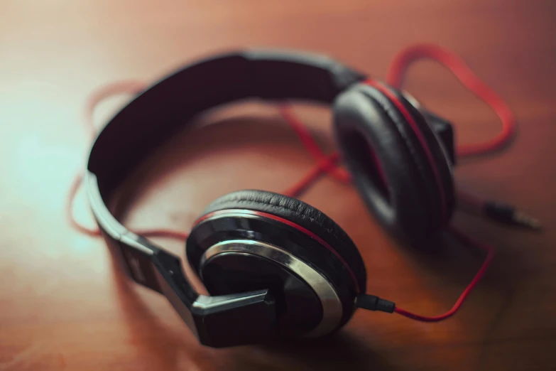 headphones sitting on top of a wooden table