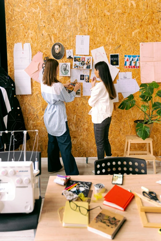 a woman looking at notes on the wall behind her