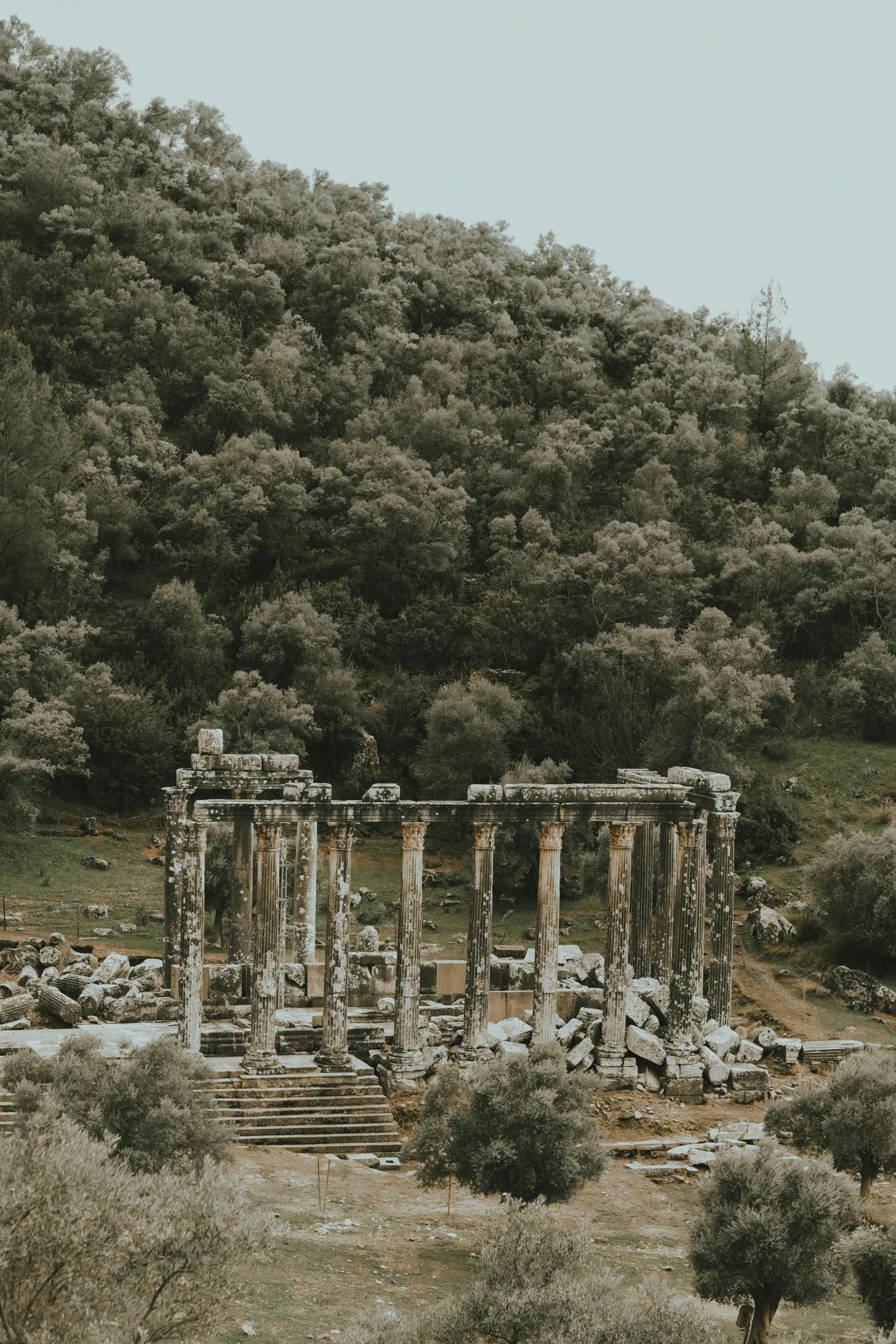 an image of a stone building near a hill