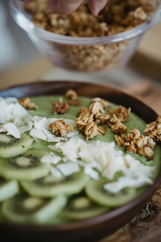 a wooden table holding a bowl with a food in it